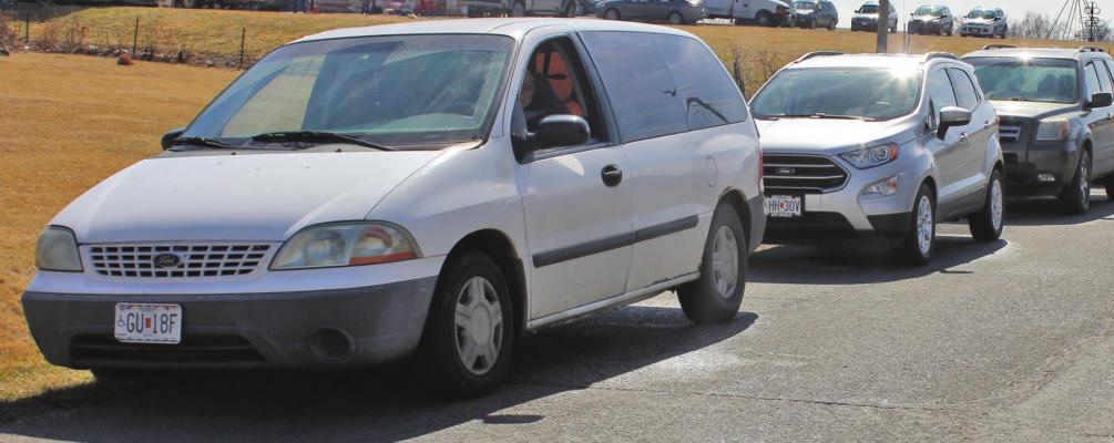 THE FIRST VEHICLE to get in line for food distribution that starts at noon Saturday arrives nearly five hours early, at 7:15 a.m. J.C. VENTIMIGLIA | Staff