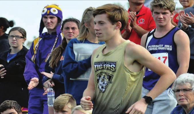 MICHAEL REBELLO, seen here going up to collect a medal at a 2019 cross country meet, hopes to have a chance to qualify for state again in boys track. SHAWN RONEY | Staff