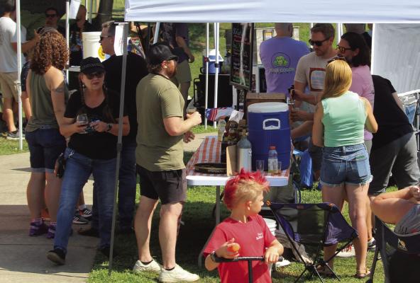 HOME BREW contestants show their products to attendees of BBQ Fly-In on the River Festival.
