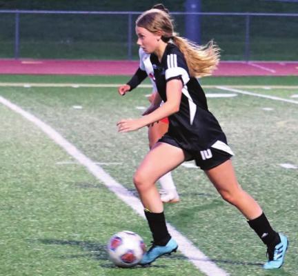 SOPHOMORE ABBY RASH looks ahead for a teammate while dribbling the ball. DUSTIN DANNER | Staff