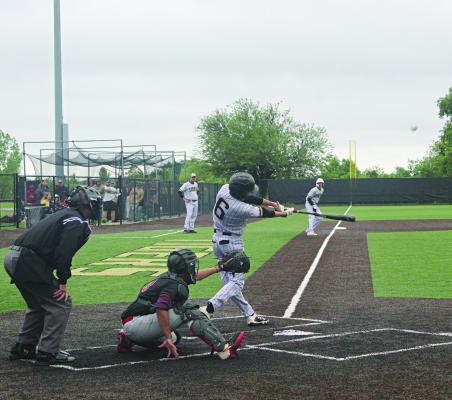 THE BASEBALL becomes a blur as Excelsior Springs senior Colson Moore sends it skyward Monday during the Tigers’ district-opening win over visiting Guadalupe Centers Charter School. MIRANDA JAMISON | Staff