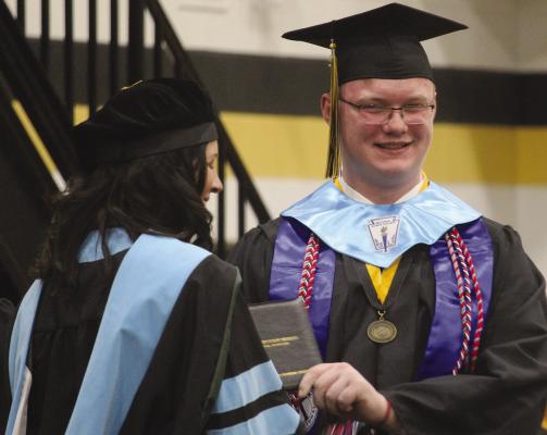 JOSHUA GOODMAN (right) receives his diploma from ESHS Principal Dr. Sara Wickham. MIRANDA JAMISON | Staff