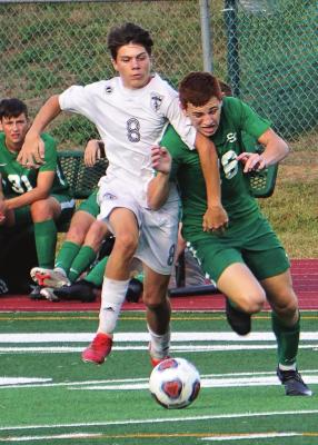 EXCELSIOR SPRINGS sophomore Mason Wartner, left, fights for possession during the Tigers’ Sept. 30 road meeting with Smithville. TIM HARLAN | Submitted