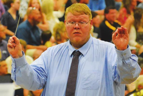 GARRETT JONES conducts as the Excelsior Springs Symphonic Band plays Clare Grundham’s arrangement of Edward Elgar’s “Pomp and Circumstance.”
