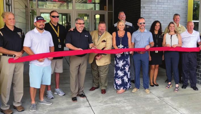 THE EXCELSIOR SPRINGS School District stages a ribbon-cutting ceremony to announce the near-completion of Cornerstone, slated to open this month. About 40 people attend the ceremony and tour the K-5 facility, Superintendent Travis Hux says. BRIAN RICE | Staff