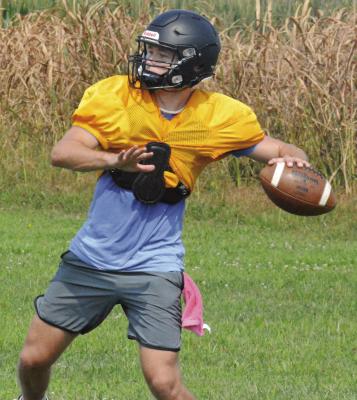 ORRICK QUARTERBACK Jeff Rohde looks downfield and prepares to throw as he and his fellow Bearcats drill over pass routes Wednesday morning on the Orrick practice field. SHAWN RONEY | Staff