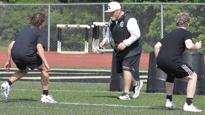 EXCELSIOR SPRINGS VARSITY COACH Jake Danneman (center) leads some younger Tigers in a drill during an offseason football camp session. SHAWN RONEY | Staff