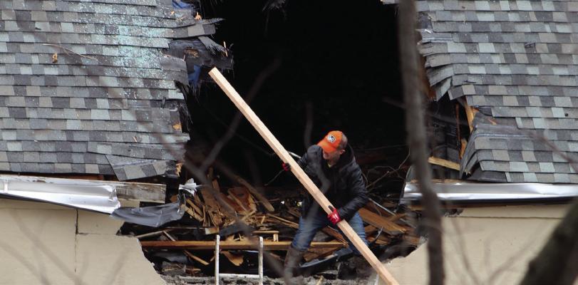WORKERS SECURE the hole in the roof of the Veterans Hall after a vehicle went airborne and crashed into the roof while fleeing from law enforcement. Immediate repair of the roof was necessary in preparation for the upcoming snow. SHARON DONAT | Staff