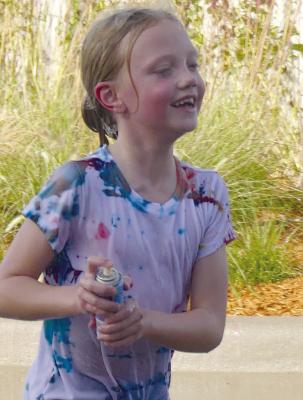 Addilyn Pollard chases other children with a can of silly string.
