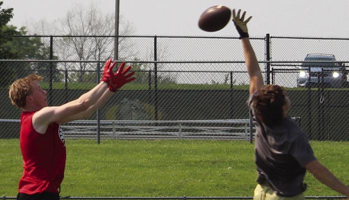 EXCELSIOR SPRINGS AND RICHMOND student-athletes compete in a passing drill during a joint summer football camp focused on fundamentals, teamwork and preseason preparation. MIRANDA JAMISON | Staff