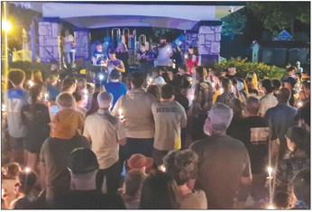 THE LAWSON community holds their candles, lit in remembrance of the student who lost their life and prays for the recovery of the student who was injured. MIRANDA JAMISON | Staff