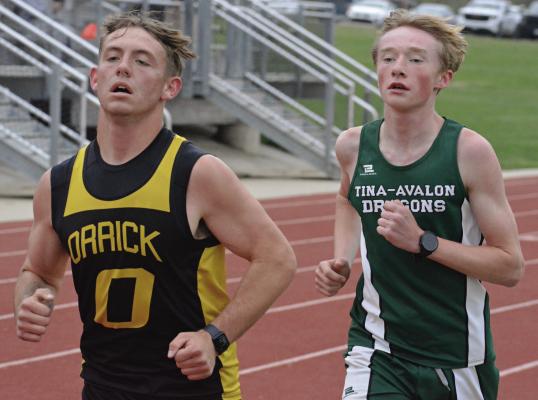 XAVIOR GASKINS (left) jockey’s with Tina-Avalon’s Landon Harper during the boys 3,200-meter run at the Bruce Finlayson Invitational. See more details on how Gaskins and his Orrick teammates fared at the varsity track and field meet on page 12 of today’s edition. SHAWN RONEY | Staff