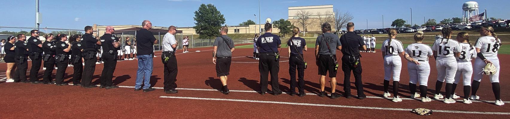 THE EXCELSIOR SPRINGS Police and Fire departments are honored during the National Anthem at the Excelsior Springs High School Softball First Responder Night. Submitted