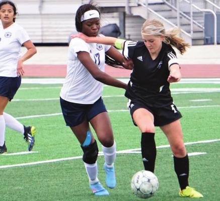 JUNIOR LAUREN MUELLER fights to get around a William Chrisman defender in tournament action. DUSTIN DANNER | Staff