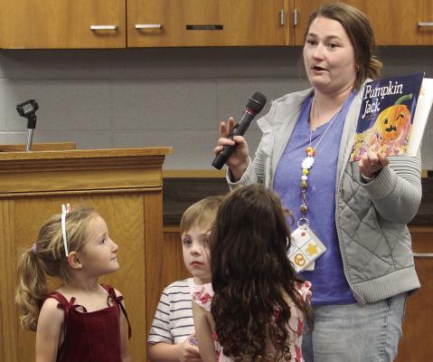 EARLY CHILDHOOD CENTER teacher Olivia McHenry (right) presents a classroom project inspired by “Pumpkin Jack” as ECC students share observations from tracking the life cycle of their classroom pumpkin. MIRANDA JAMISON | Staff