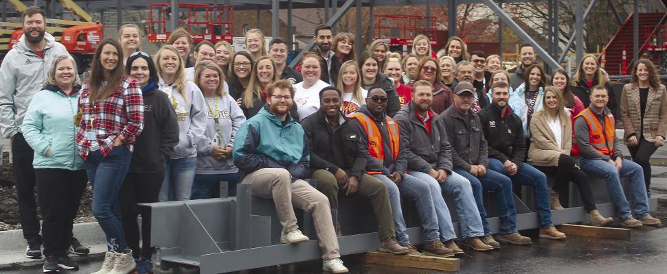 LEWIS ELEMENTARY School teachers accept their invitation to the site of the new school building and smiled with Newkirk Novak Construction Partners staff before signing a beam that will become part of the building. MIRANDA JAMISON | Staff