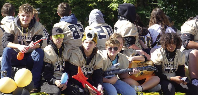 FOOTBALL PLAYERS rock out on their float through the parade. ELIZABETH BARNT | Staff