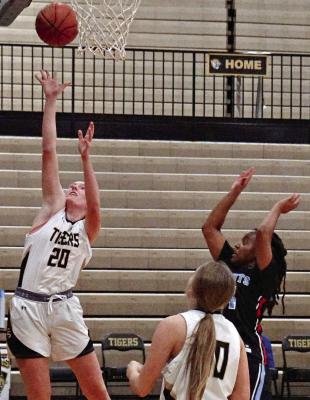 KINLEY ROGERS (left), shown shooting last season amid traffic around the basket, has been a contributing scorer and rebounder for Excelsior Springs to start this varsity girls basketball season. DUSTIN DANNER | Staff
