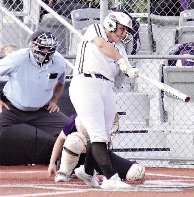 EXCELSIOR SPRINGS senior Daelyn Williams watches a pitch jump off her bat during the Tigers’ Sept. 6 win against North Kansas City. DUSTIN DANNER | Staff