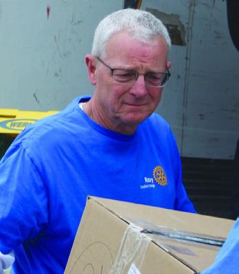 EXCELSIOR SPRINGS ROTARIAN Mike Edwards helps load boxes of shoes. SHARON DONAT | Staff