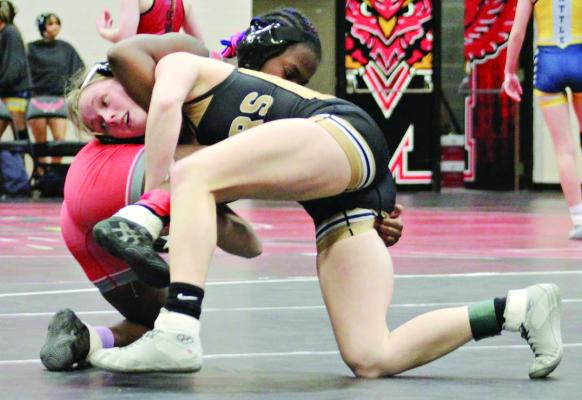JAYLENN HUDLEMEYER (right) shoots for a takedown during Jan. 24 quadrangular action at Marshall. DUSTIN DANNER | Staff