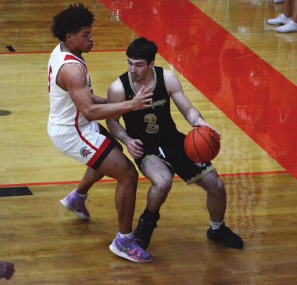 EXCELSIOR SPRINGS senior Gannon Willis, right, finds himself one on one against Richmond senior Keyshaun Elliott in the paint during the Tigers’ March 1, season-ending loss to the Spartans in the Class 4 District 15 Tournament at Oak Grove High School. SHAWN RONEY | Staff