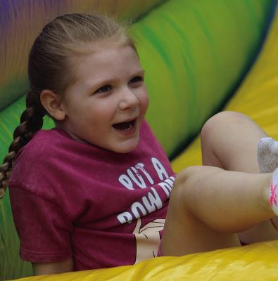 SKYLAR MARTINEZ slides down an inflatable during Crescent Lake Christian Center’s Family Fun Day festivities. SHARON DONAT | Staff