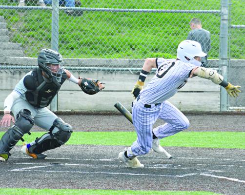 EXCELSIOR SPRINGS SOPHOMORE Ryne Marcum promptly drops his bat and bolts toward first base after putting down a bunt during the Tigers’ epic varsity baseball game with Kearney Monday at Tiger Stadium. SHAWN RONEY | Staff