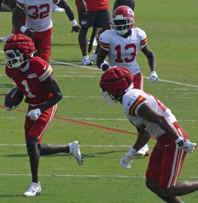 CHIEFS WIDE RECEIVER Xavier Worthy (left) eludes some of his Kansas City teammates on a catch-and-run play and helps make attending training camp a blast. SHAWN RONEY | Staff