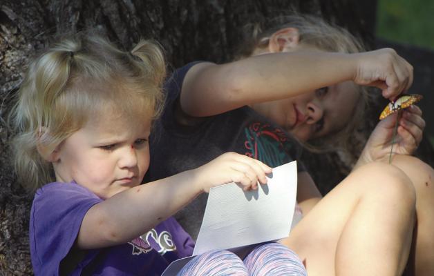 ELLIOT (LEFT) AND MACY MCCARTHY create a fall-themed craft during the Fall on the Farm event Saturday at Watkins Woolen Mill State Historic Site and State Park. SHARON DONAT | Staff