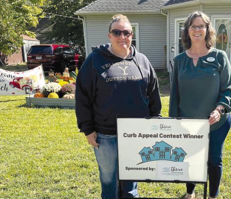 BECCA ANDERSON (left) was named the Thrive Curb Appeal Contest winner by Neighborhood Specialist Laura Mize. MIRANDA JAMISON | Staff