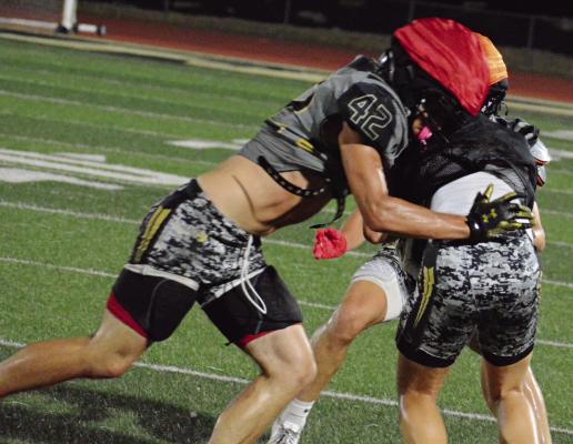 GAIGE HADDOCK makes a tackle as he and his fellow Tigers continue their preseason workouts during the Black and Gold scrimmages. SHAWN RONEY | Staff