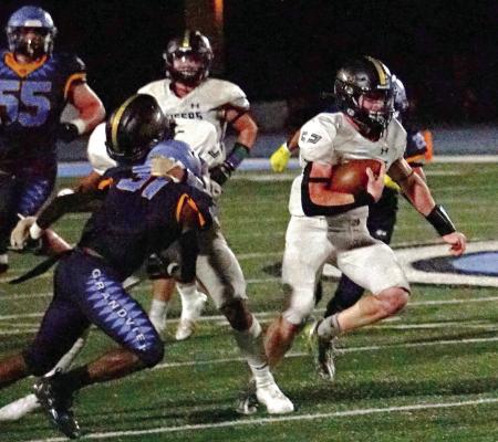 WITH THE FOOTBALL firmly tucked under his right arm, Excelsior Springs junior Dawson Claypole finds running room during the fourth quarter of the Tigers’ Sept. 29 road meeting with Grandview. TIM HARLAN | Staff