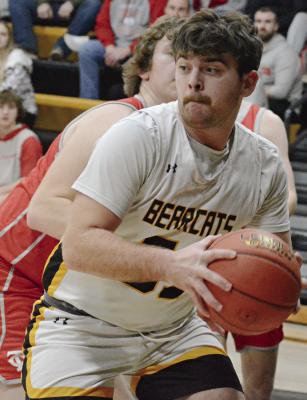 SENIOR TUCKER GREER keeps both hands on the basketball during the first half of Orrick’s varsity boys meeting with Carrollton. Greer goes on to sink one of two free throws with seconds left in the fourth quarter to help the Bearcats pull out a 52-51 victory. SHAWN RONEY | Staff
