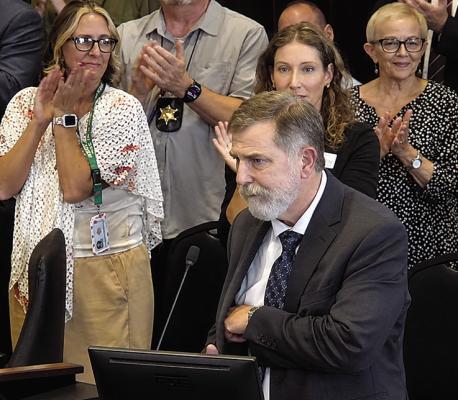 JUDGE SHANE T. ALEXANDER becomes emotional as attendees give him a standing ovation following a resolution honoring his judicial service. Submitted