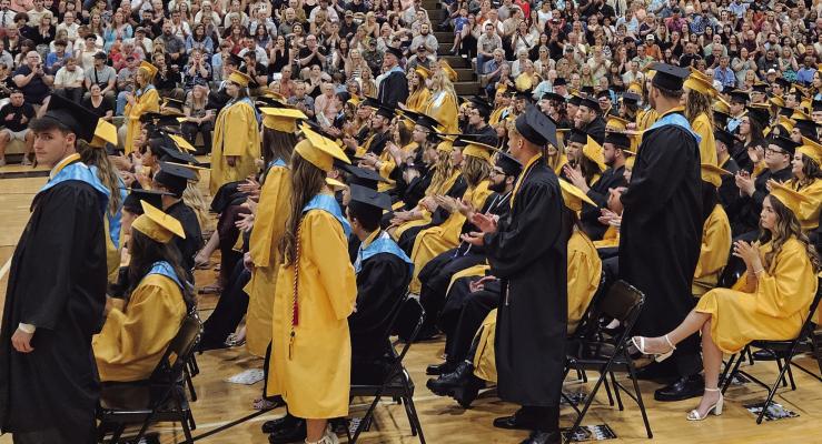 ESHS GRADUATES stand to be honored for their academic achievements. MIRANDA JAMISON | Staff