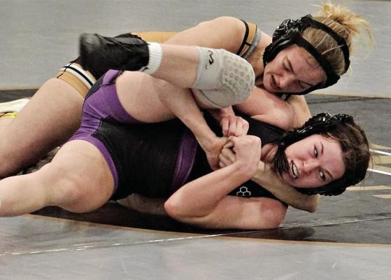 JUNIOR ALYSSA BETTS, top, secures a cradle hold and gets a win by pin in the 125-pound match during Excelsior Springs’ Jan. 11 home dual loss to Kearney. DUSTIN DANNER | Staff