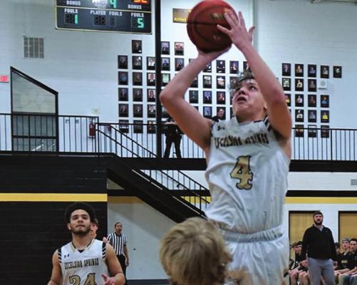 JUNIOR RAKAI GANTT looks to score over Savannah defenders during the Tigers’ 58-50 loss to the Savages Feb. 21 at Excelsior Springs. DUSTIN DANNER | Staff
