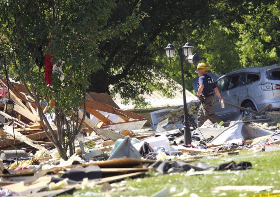 EXCELSIOR SPRINGS AND Fishing River firefighters extinguish a reignited fire previously caused by an explosion and douse the area to prevent reignition. MIRANDA JAMISON | Staff