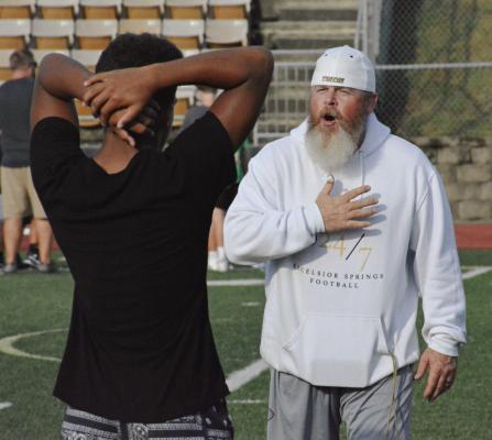EXCESLIOR SPRINGS VARSITY football coach Jake Danneman (right), shown instructing middle schoolers recently during a camp at Tiger Stadium, sees potential in his high schoolers entering the regular season. SHAWN RONEY | Staff