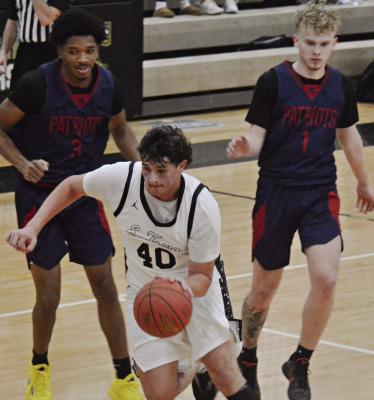 JUNIOR BRODY QUERRY (center) drives to the bucket during the first half of Excelsior Springs’ varsity boys basketball game with Truman. DUSTIN DANNER | Staff