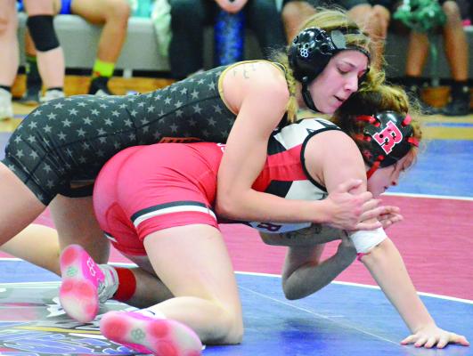 WORKING FROM the top position, Nevaeh Happy attempts to break down Richmond’s Holly Meredith during the Drew Emerson Invitational. SHAWN RONEY | Staff