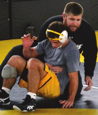 EXCELSIOR SPRINGS senior Ayden Dolt, seen receiving instruction from coach Cody Beck, looks to win another state boys wrestling title. DUSTIN DANNER | Staff