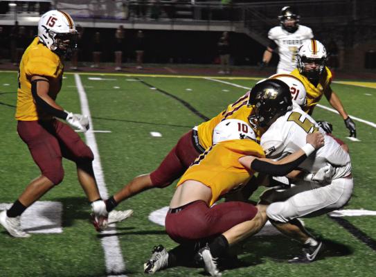 CARSON GHOLSON (No. 5) drags two Winnetonka defenders with him on a catch-and-run play for Excelsior Springs Sept. 6 at Winnetonka. DUSTIN DANNER | Staff