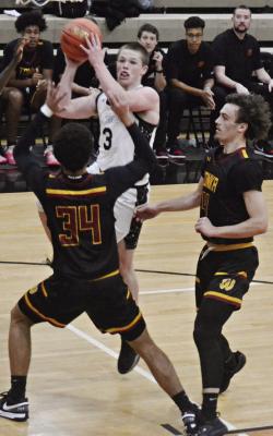 KLAYTON GLASPY (center) attempts a layup against Winnetonka. DUSTIN DANNER | Staff