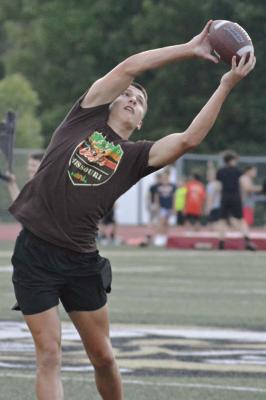OWEN O’DELL snags a pass while playing catch with Lukas Varty at youth football camp. SHAWN RONEY | Staff