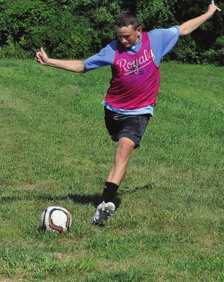 EXCELSIOR SPRINGS freshman Easton Ryan tees off as the Tigers play a short round of footgolf July 29 during the last day of boys soccer team camp. SHAWN RONEY | Staff