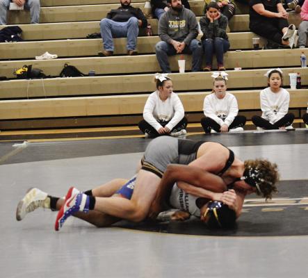 EXCELSIOR SPRINGS sophomore Hunter Scoma, top, works to turn his opponent during a Dec. 7 triangular hosted by the Tigers. DUSTIN DANNER | Staff