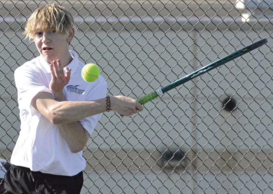 SOPHOMORE NOAH DUNKER watches one of his shots during Excelsior Springs’ varsity boys tennis dual with Carrollton. SHAWN RONEY | Staff