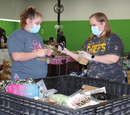 AT THE REOPENING Saturday of Diggers, 1218 N. Jesse James Road, Excelsior Springs, shoppers Ashlyn and Gail Calvert seek bargains.
